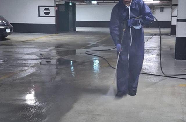 Pressure washing an underground parking garage in Ottawa