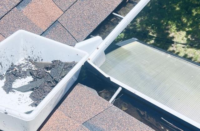Gutter filled with leaves before cleaning in Gatineau